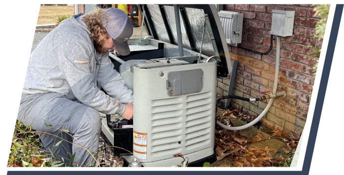 an electrician for e&w works on an open generator on the side of an exterior brick wall
