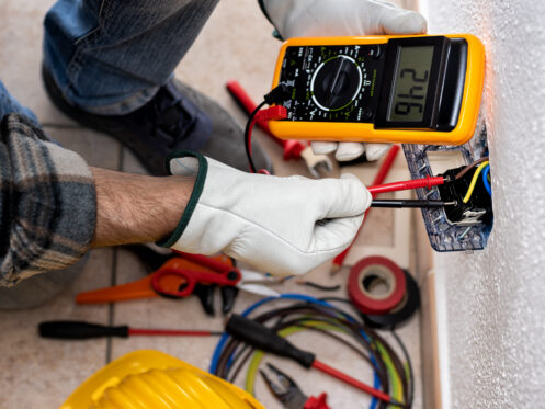 Electrician at work on a residential electrical system.