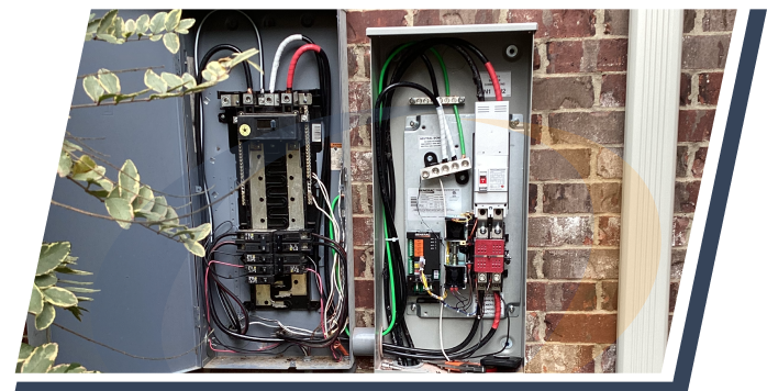 on an exterior brick wall, two electrical panel boxes are open showing wires and fuses