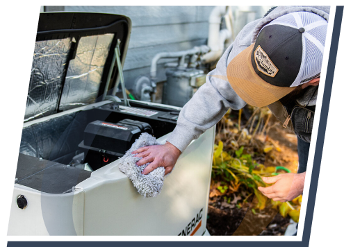 someone wipes down a generac generator outside next to someone's home